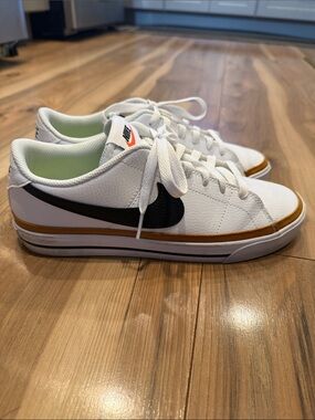 Nike White Low-Top Sneakers with Black Swoosh and Brown Trim